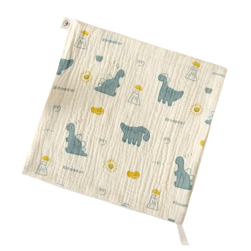 Cream washcloth with teal dinosaur prints and yellow details.