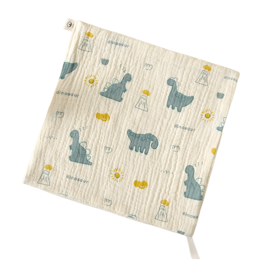Cream washcloth with teal dinosaur prints and yellow details.