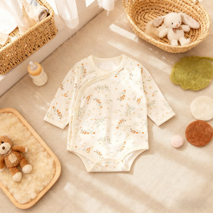 Baby onesie with animal prints on a neutral background with toys and a basket.