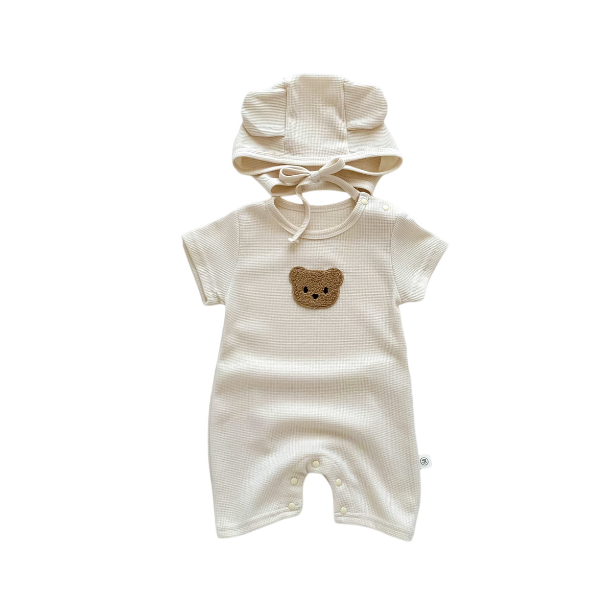 Baby romper with bear face design and matching hat on a white background