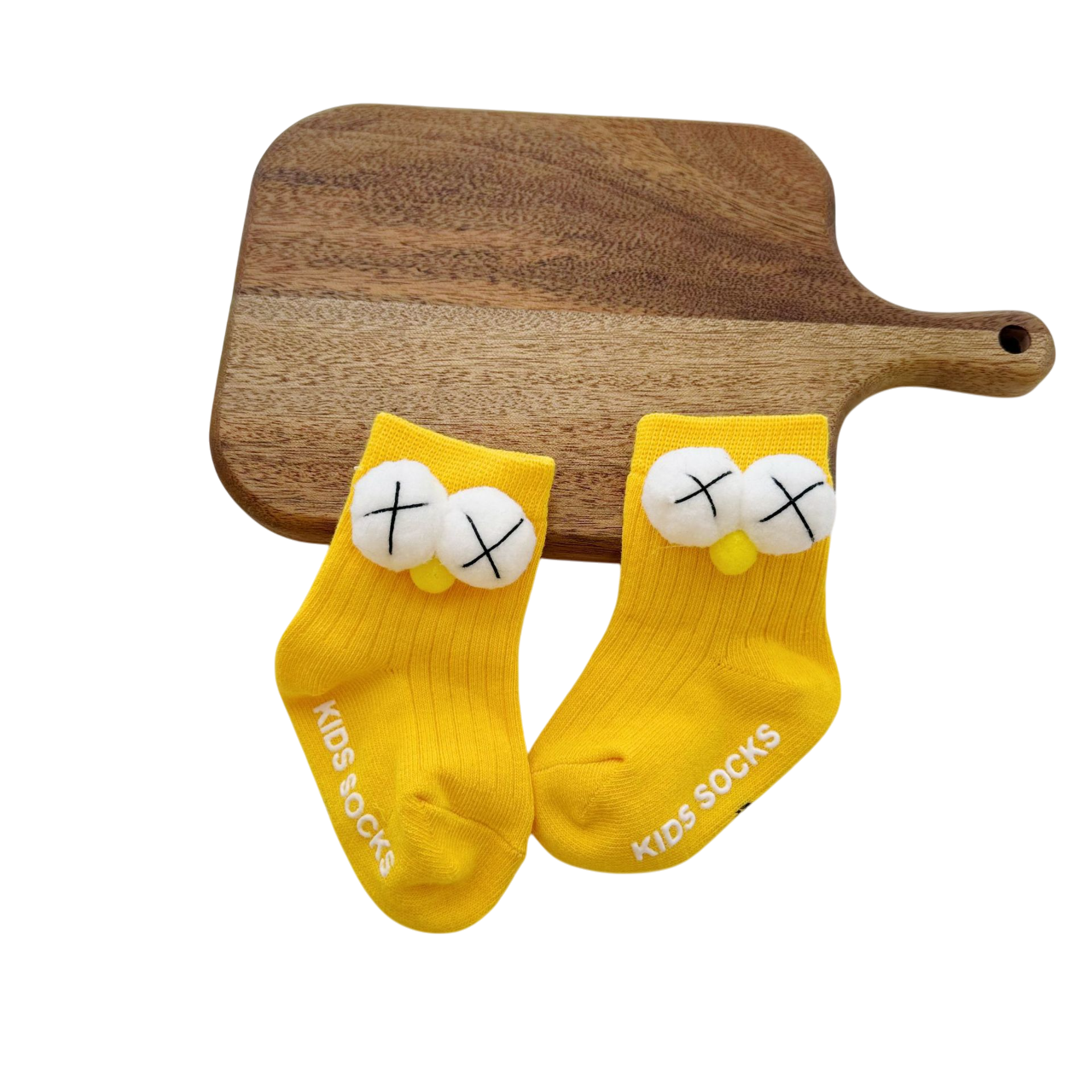 Yellow socks with cartoon face design on a wooden board