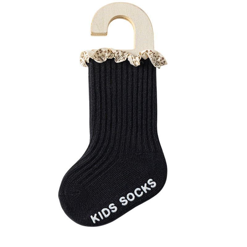 Black kids sock with lace trim on a hanger against a white background