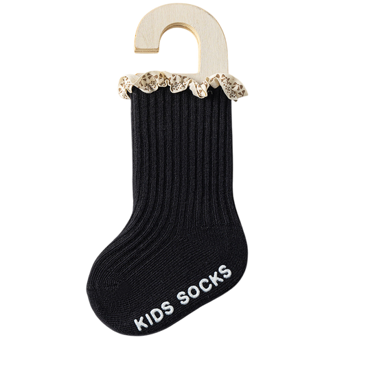 Black kids sock with lace trim on a hanger against a white background