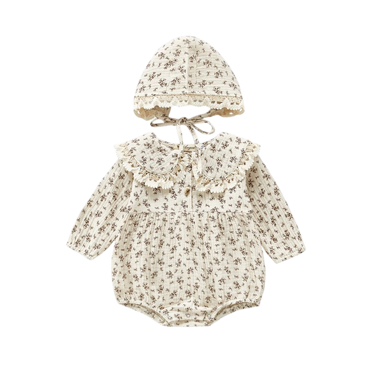 Baby romper with floral pattern and matching hat on a white background