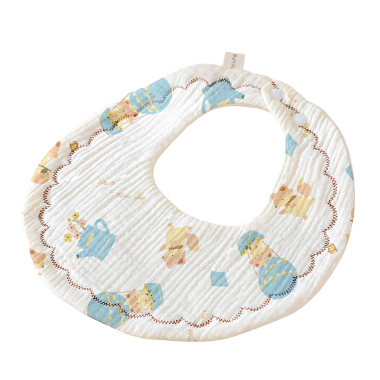Baby bib with teddy bear and teapot pattern on a white background