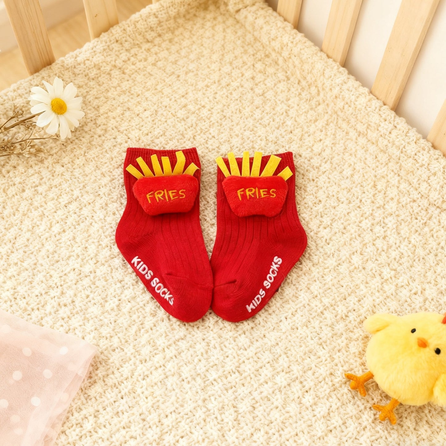 Red socks with yellow fries design and white text on a textured surface.