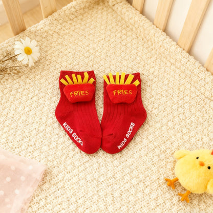Red socks with yellow fries design and white text on a textured surface.