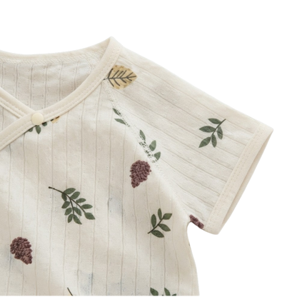 Close-up of the short sleeve and botanical print on the cream baby bodysuit