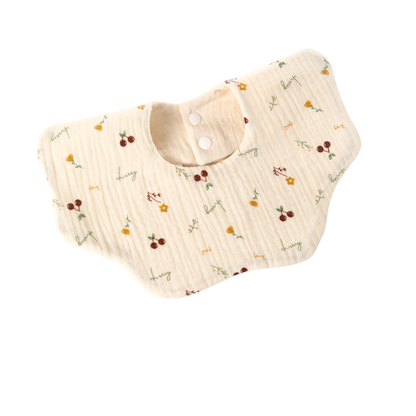 Beige baby bib with floral pattern on a white background