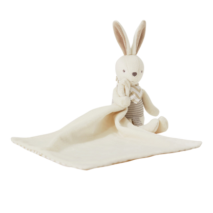 Stuffed rabbit toy with a white blanket on a white background
