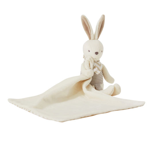 Stuffed rabbit toy with a white blanket on a white background