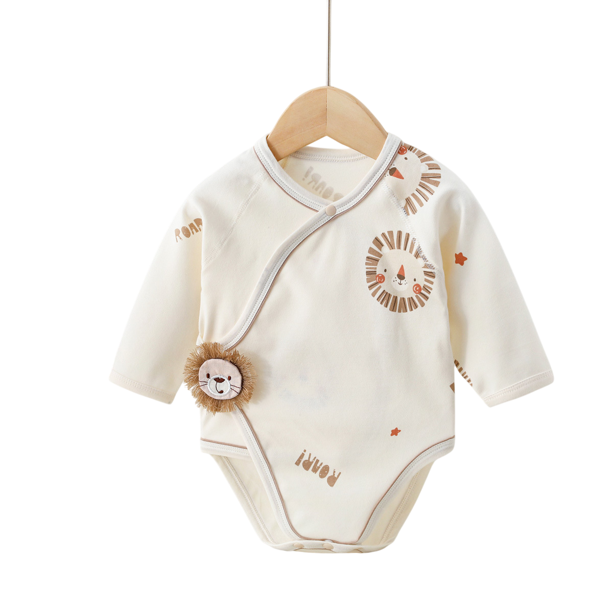 Baby onesie with lion design on a wooden hanger against a white background