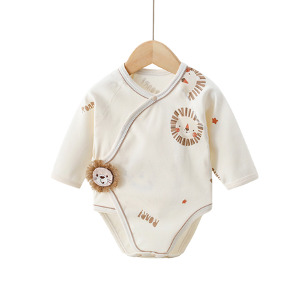 Baby onesie with lion design on a wooden hanger against a white background