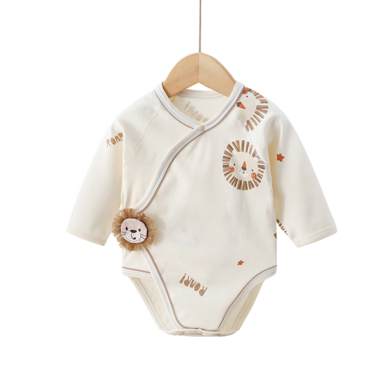 Baby onesie with lion design on a wooden hanger against a white background
