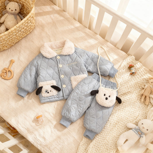 Children's quilted jacket and pants set with bear patches on a crib with toys around.